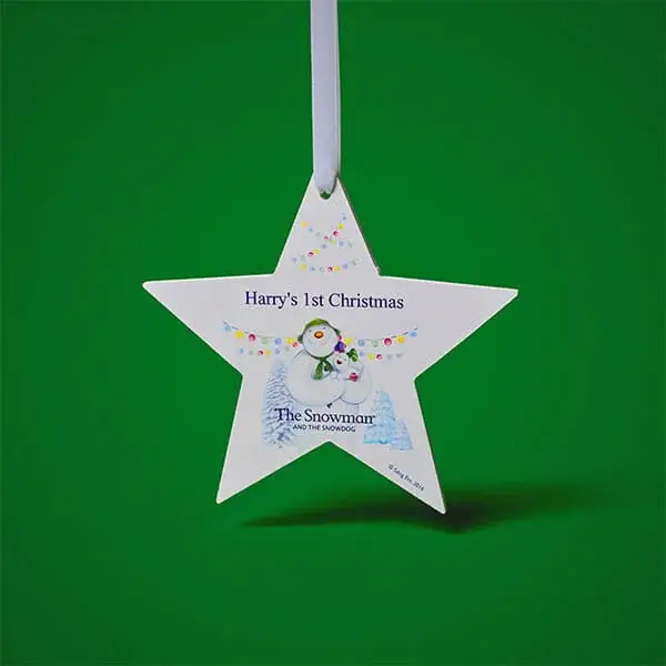 Personalised star-shaped Christmas tree decoration featuring The Snowman™ character and a first Christmas message.
